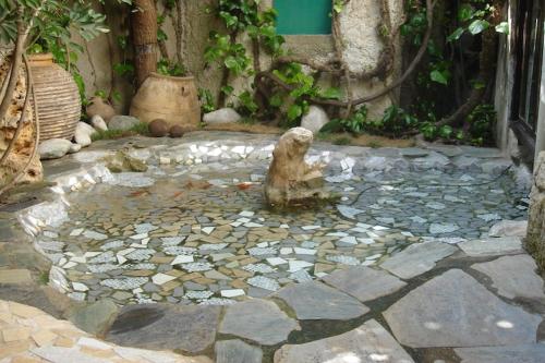 a statue of a dog sitting in a pond of water at Villa in Giannoudi with Pool and Beach Nearby in Giannoudi