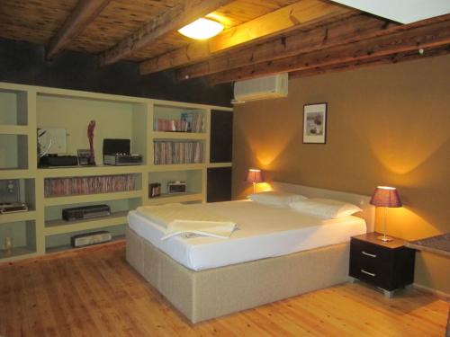 a bedroom with a large bed and a book shelf at Villa in Giannoudi with Pool and Beach Nearby in Giannoudi