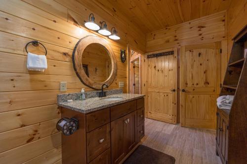 a bathroom with a sink and a mirror at Anglers Ridge by American Patriot Getaways in Richardson Cove