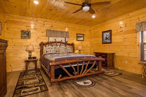 a bedroom with a bed in a log cabin at Anglers Ridge by American Patriot Getaways in Richardson Cove