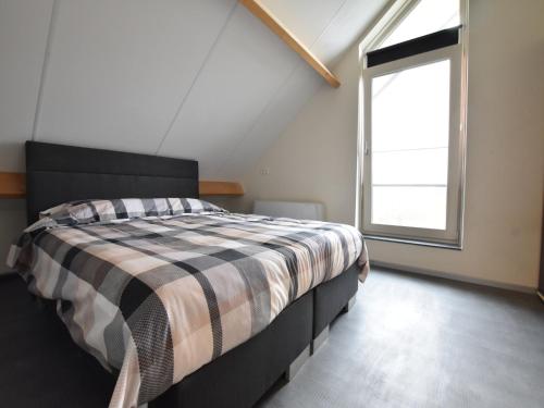 a bedroom with a bed and a large window at Villa in Luttenberg near National Park in Luttenberg