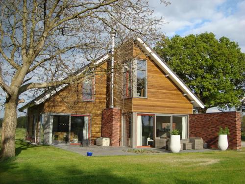 a brick house with glass doors on a yard at Villa in Luttenberg near National Park in Luttenberg