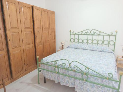 a bedroom with a bed and wooden cabinets at ROSA BLU House in Pisa