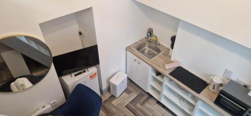 a small bathroom with a sink and a mirror at Loft Style-1Br-WalkinShower-WiFi-Central Cork in Cork