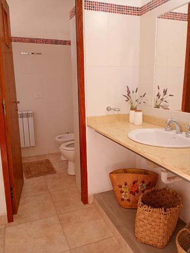 a bathroom with a sink and a toilet at La Carmela, Tilcara in Tilcara