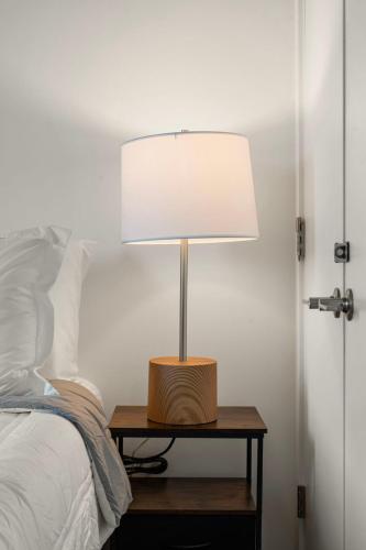 a lamp on a table next to a bed at Family-Sized 4BR Luxury in Downtown Chicago in Chicago