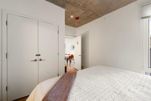 a bedroom with a bed and white walls and a ceiling at Family-Sized 4BR Luxury in Downtown Chicago in Chicago