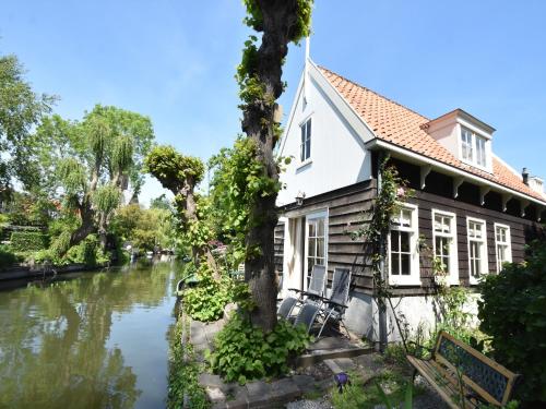 a house next to a river at Serene Getaway in Edam in Edam