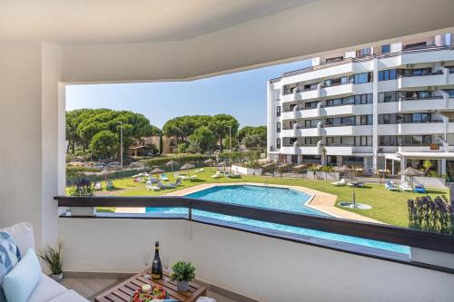 a view from the balcony of a building with a swimming pool at Vilamoura Retreat with Pool & Balcony by HostWise in Quarteira