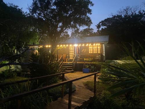 a house lit up at night with lights at Little Creek Cabins in Port Edward
