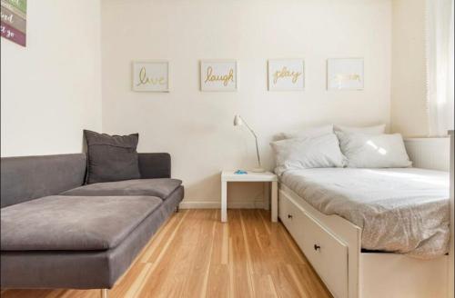 a bedroom with a bed and a couch and a table at Beautiful suite in the best location in Miami! in Miami