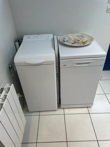 two refrigerators sitting next to each other in a kitchen at Sweet'Nest Dinard - Le Charme Breton in Dinard