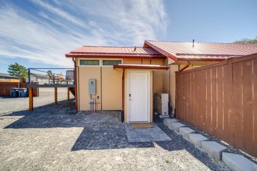a house with a white door and a fence at Steps to Soap Lake Studio Stay with Patio! in Soap Lake