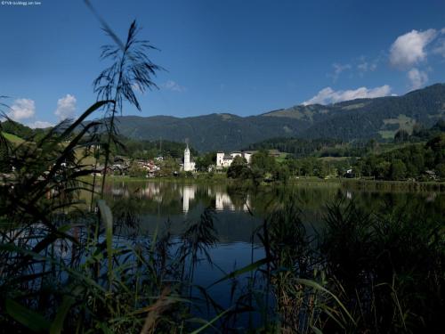 a view of a lake with a town and mountains at Mansion in Goldegg near Ski Lift in Goldegg