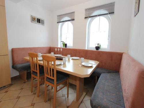 a dining room with a wooden table and chairs at Mansion in Goldegg near Ski Lift in Goldegg