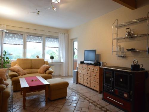 a living room with a couch and a tv at Ferienwohnung Schwebebahn in Wuppertal in Wuppertal