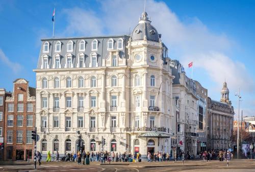 a large building with people standing outside of it at Park Plaza Victoria Amsterdam in Amsterdam