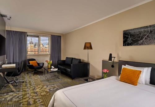 a hotel room with a bed and a desk at Park Plaza Victoria Amsterdam in Amsterdam