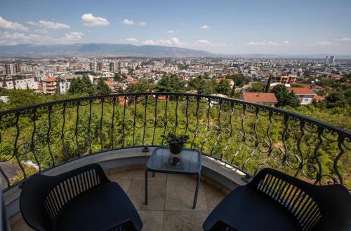 a balcony with two chairs and a table at View Inn Boutique Hotel in Skopje