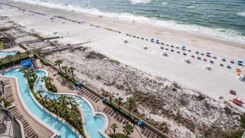 an aerial view of a beach and a swimming pool at Phoenix West 1103 in Orange Beach