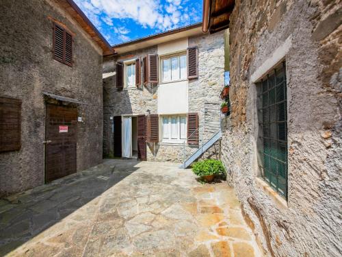 an alley in an old stone building with a door at Holiday Home in Pascoso near Forest in Pescaglia