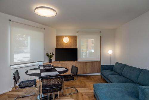 a living room with a couch and a table at Bertamini Apartments in Nago-Torbole