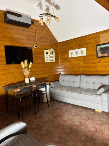 a living room with a couch and a table at Naša Oaza - Donja Trepča, Čačak 