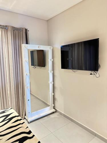 a room with a mirror and a tv on the wall at Departamento Sognare in Encarnación