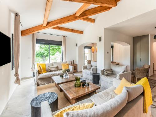 a living room with couches and a table at Holiday Home in Vaison la Romaine with Pool in Vaison-la-Romaine