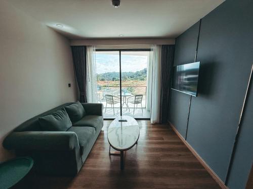 un salon avec un canapé et une table en verre dans l'établissement FAMILY HOMES Wyndham - Spacious 2BDRM Just Steps from Rawai Beach, à Ban Saiyuan (1)