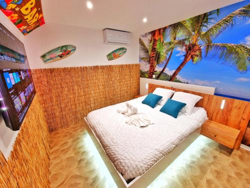 a bedroom with a bed with a palm tree mural at PLAYA SPA-4 Pers-Jacuzzi-Parking-Jardin-Clim-Colmar in Muntzenheim