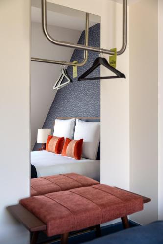 a bedroom with a large bed with red pillows at Maison du Lac Boutique Hôtel in Nyon