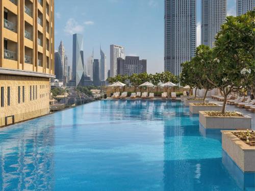 a large swimming pool in the middle of a city at Creston Suites The Dubai Mall Residences in Dubai