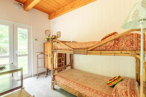 a bedroom with two bunk beds in a room at 8 beds- surrounded by greenery with parking in Uscio