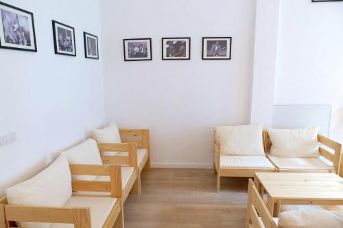 a room with couches and tables and pictures on the wall at bcool in Bilbao