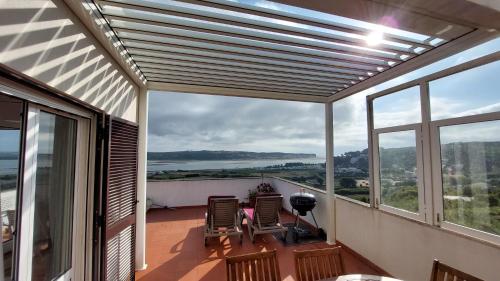 a balcony with a view of the water at Casa Feliz Obidos Lagoon and sea view in Foz do Arelho