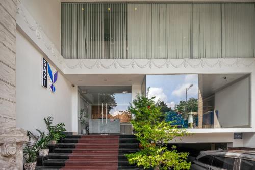 a building with stairs and plants in front of it at SAZI Erato Hotel - Free Airport & Breakfast in Ho Chi Minh City