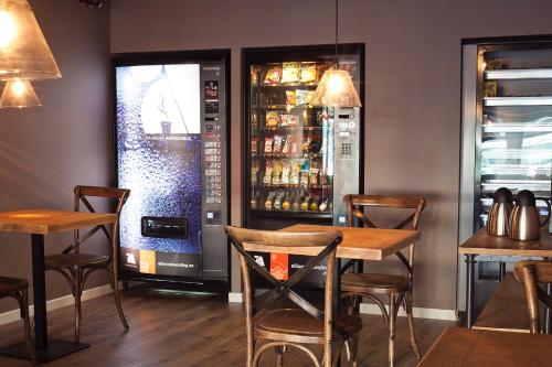 a restaurant with a table and a drink machine at Hotel Acta Madfor in Madrid
