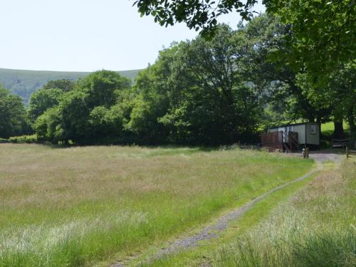 a field with a dirt road in the middle at 1 Bed in Longtown 44235 in Longtown