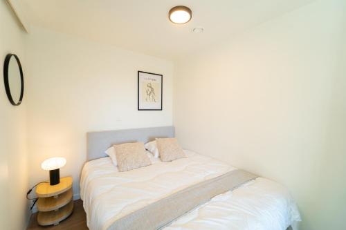a bedroom with a bed in a white room at Fourstay Luxury City Apartments Diegem - Brussels in Diegem