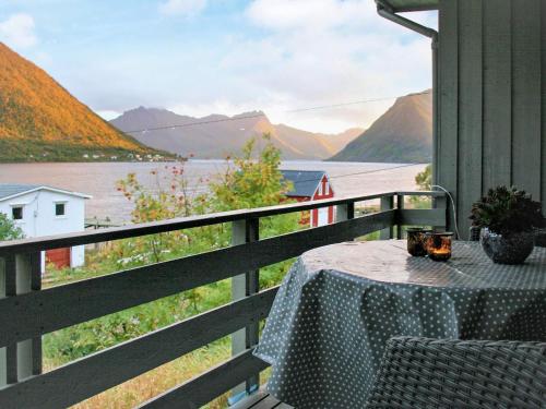 a table on a balcony with a view of a lake at 8 person holiday home in Kaldfarnes in Kaldfarnes