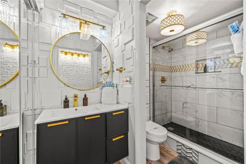 a bathroom with a sink and a toilet and a mirror at Skyline & Sand in Daytona Beach