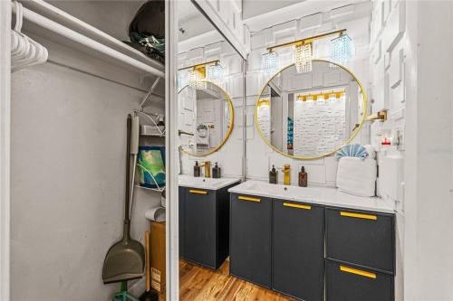 a bathroom with two sinks and two mirrors at Skyline & Sand in Daytona Beach