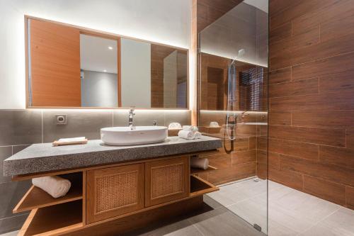 a bathroom with a sink and a mirror at Renjana Villas in Ubud