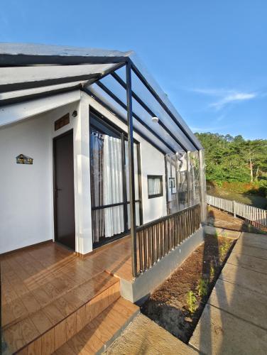 a balcony of a house with a deck at Luma Senja Villa WFA, WFH, Workspace & Honeymoon Puncak Dua in Cikuray