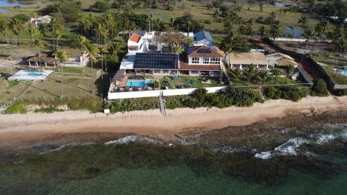 an aerial view of a house on the beach at Pousada a Capela in Arembepe