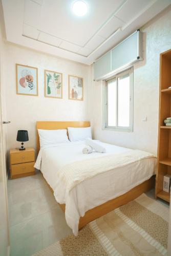 a bedroom with a large bed and a window at Ocean View and Fast Wifi in Tangier
