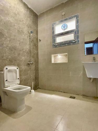 a bathroom with a toilet and a sink at شقق وفلل بيوت السلام in Salalah