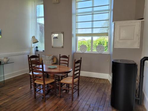 a dining room with a table and chairs and a window at Holiday Home in Limousin near Forest in Sainte-Anne-Saint-Priest