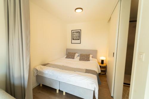 a small bedroom with a bed in a room at Fourstay Luxury City Apartments Diegem - Brussels in Diegem